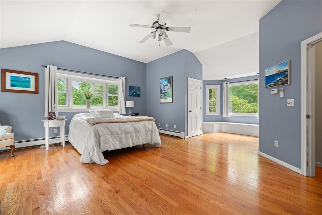 91 Canoe Tree Way Marshfield, MA 02050 - Photo 14 of 35 a bedroom with a bed and a chandelier