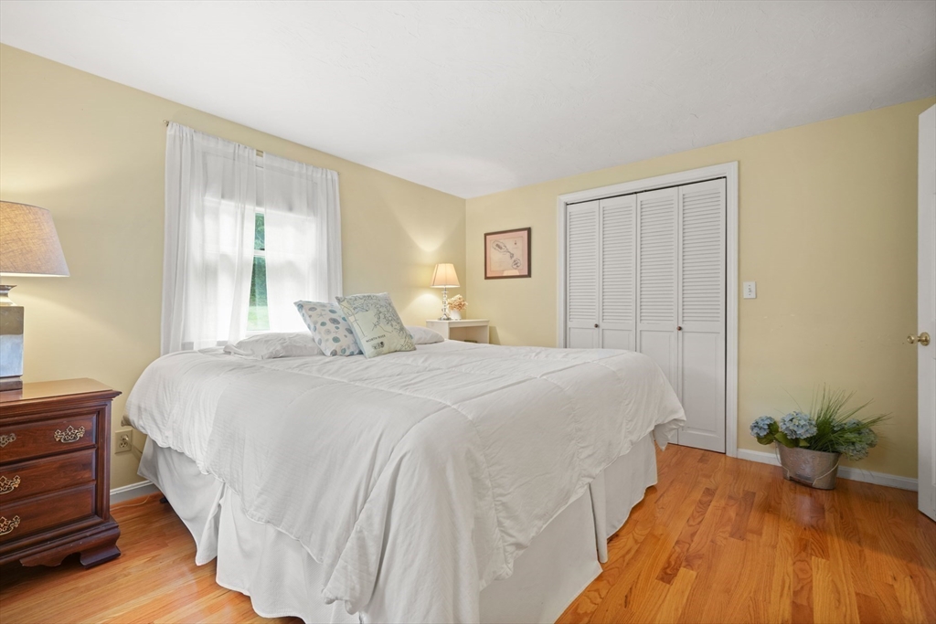 91 Canoe Tree Way Marshfield, MA 02050 - Photo 18 of 35 a spacious bedroom with a bed and a window
