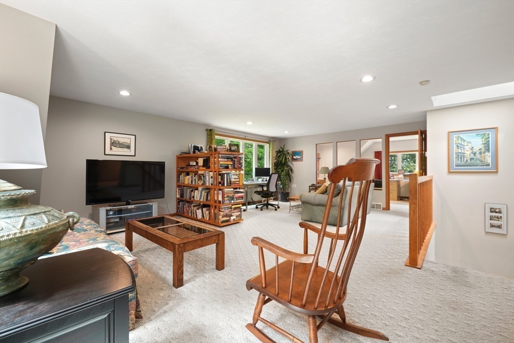 91 Canoe Tree Way Marshfield, MA 02050 - Photo 20 of 35 a view of a livingroom with furniture and a flat screen tv