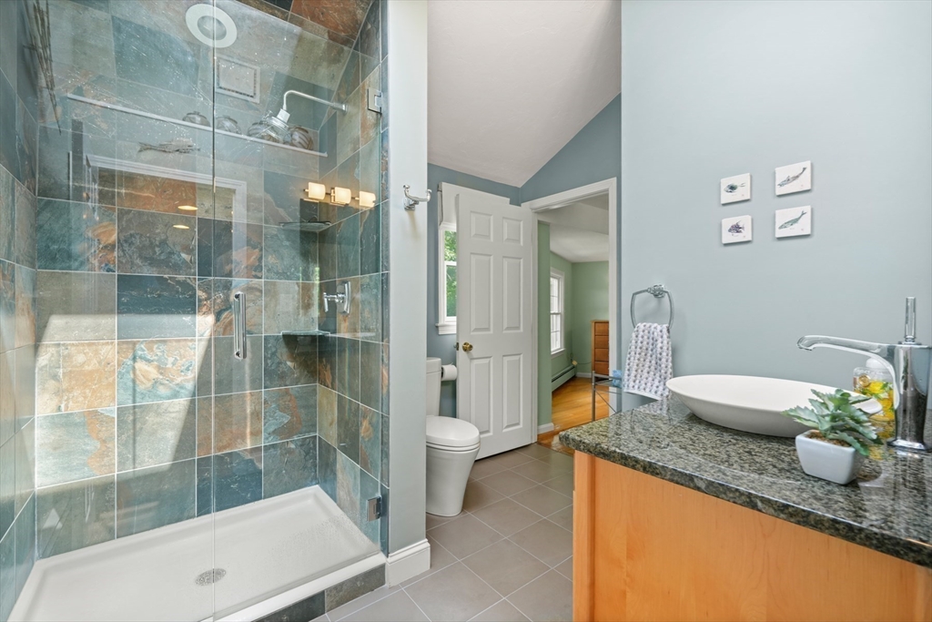 91 Canoe Tree Way Marshfield, MA 02050 - Photo 25 of 35 a bathroom with a granite countertop sink a toilet and shower