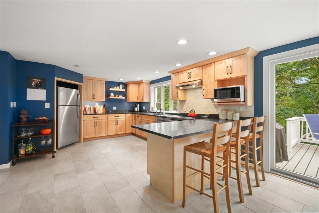 91 Canoe Tree Way Marshfield, MA 02050 - Photo 10 of 35 a kitchen with stainless steel appliances granite countertop a refrigerator and a stove top oven