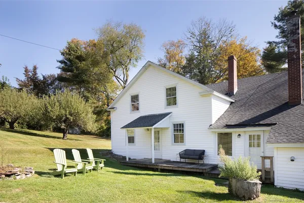 a front view of house with yard swimming pool and outdoor seating