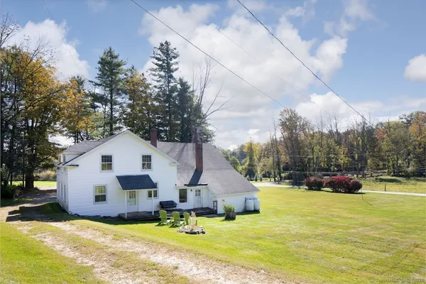 a view of a house with a yard covered with snow in front of house
