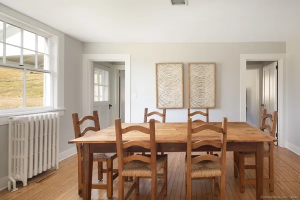 a view of a dining room with furniture and window