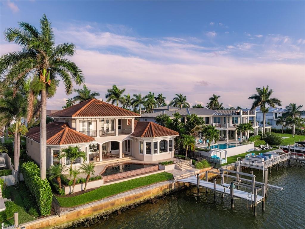 1942 Kingfish Road Naples, FL 34102 - Photo 40 of 43 a front view of a house with a boat