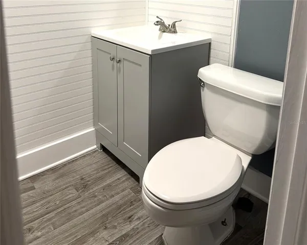 a white toilet sitting next to a bathroom sink