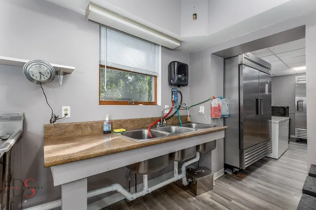 a view of a brick house with a yard table and chairs