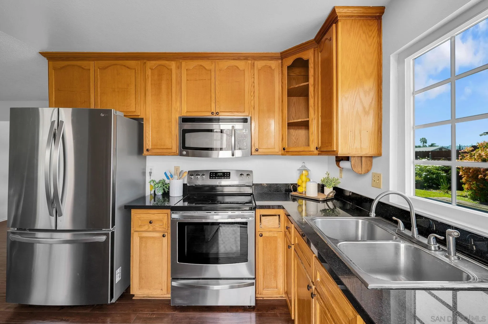 10834 Buggywhip Drive Spring Valley, CA 91978 - Photo 11 of 36 a kitchen with a refrigerator a sink and a stove