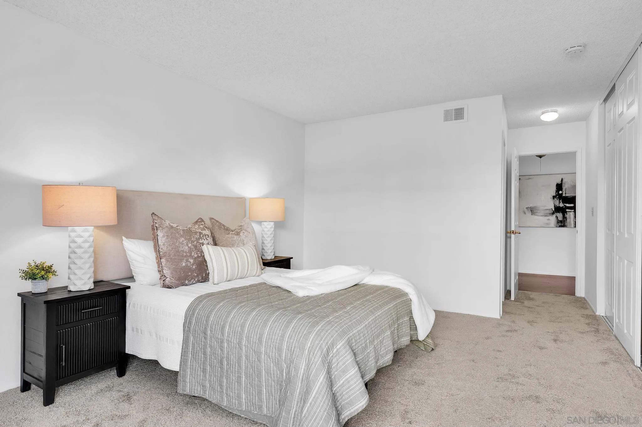 10834 Buggywhip Drive Spring Valley, CA 91978 - Photo 14 of 36 a bedroom with a bed and a lamp