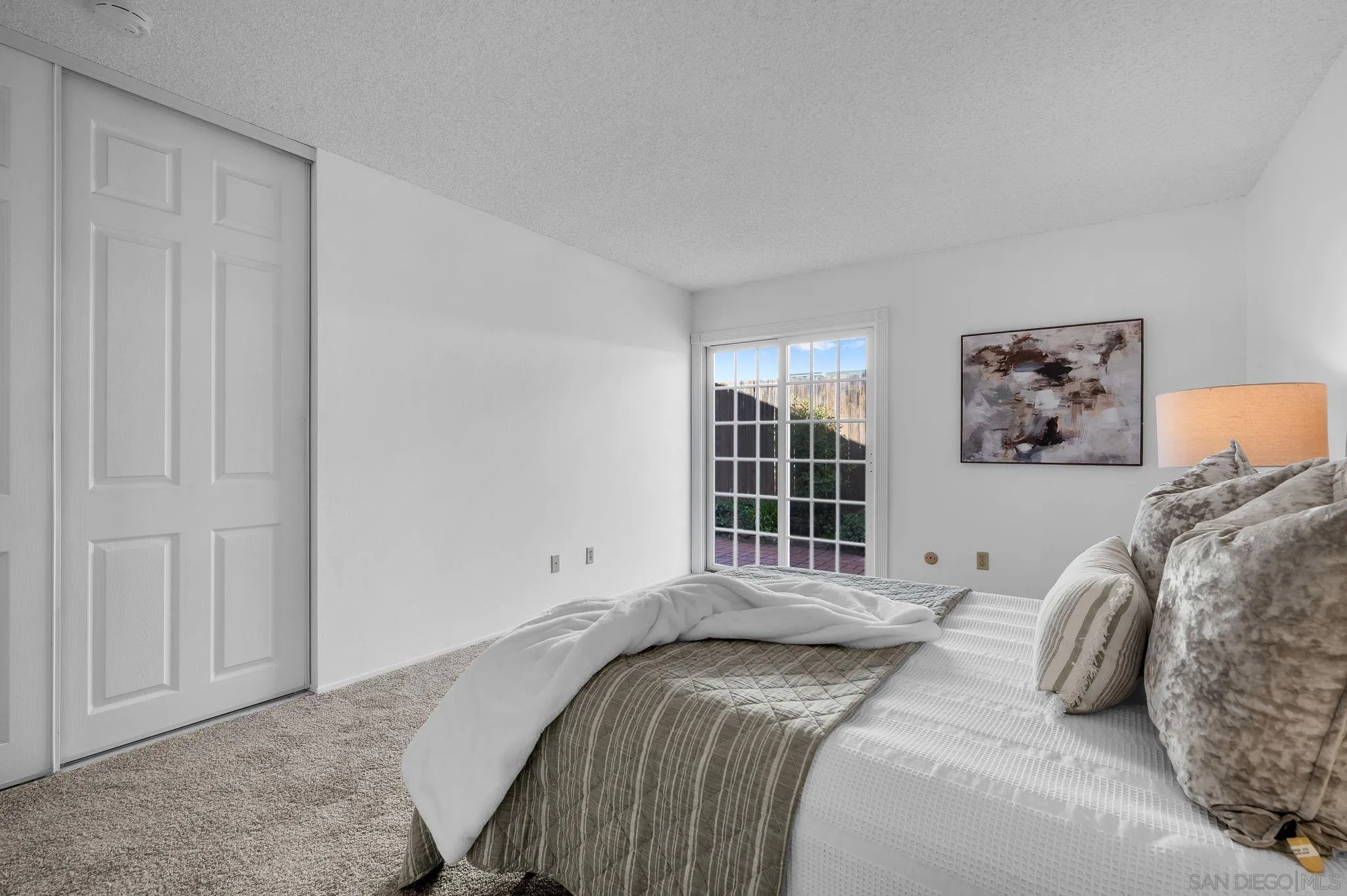 10834 Buggywhip Drive Spring Valley, CA 91978 - Photo 15 of 36 a bedroom with a large bed and a window