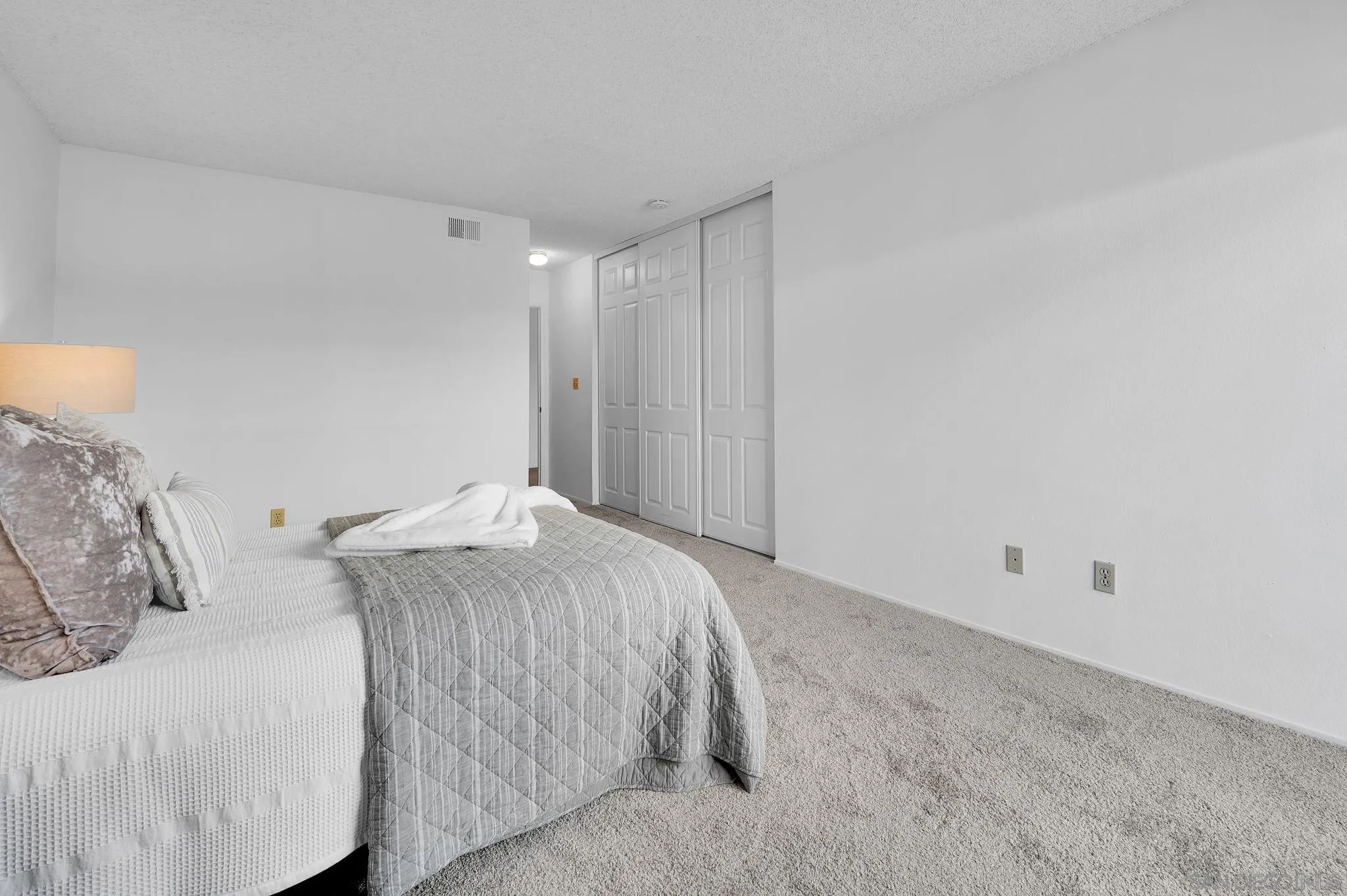 10834 Buggywhip Drive Spring Valley, CA 91978 - Photo 16 of 36 a bedroom with a bed and a night stand