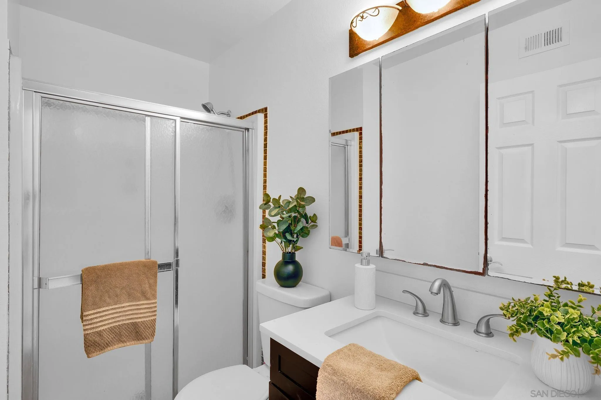 10834 Buggywhip Drive Spring Valley, CA 91978 - Photo 17 of 36 a bathroom with a sink a toilet and a mirror