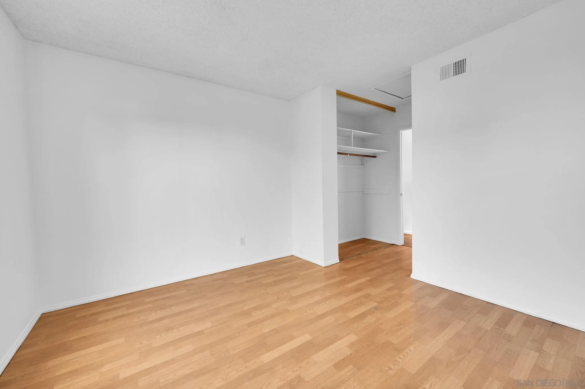 10834 Buggywhip Drive Spring Valley, CA 91978 - Photo 20 of 36 a view of empty room with wooden floor