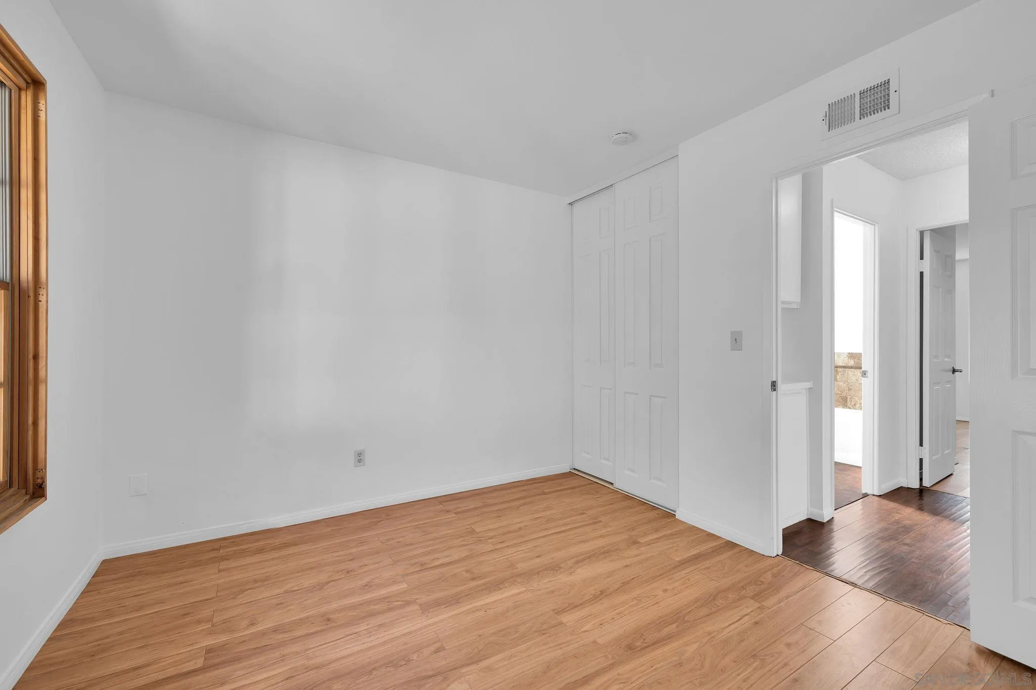 10834 Buggywhip Drive Spring Valley, CA 91978 - Photo 22 of 36 a view of empty room with wooden floor and fan