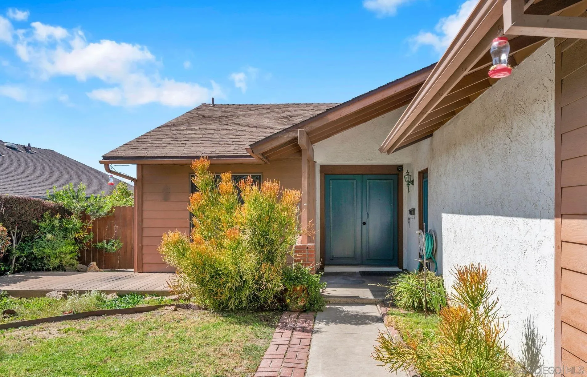 10834 Buggywhip Drive Spring Valley, CA 91978 - Photo 24 of 36 a front view of a house with garden