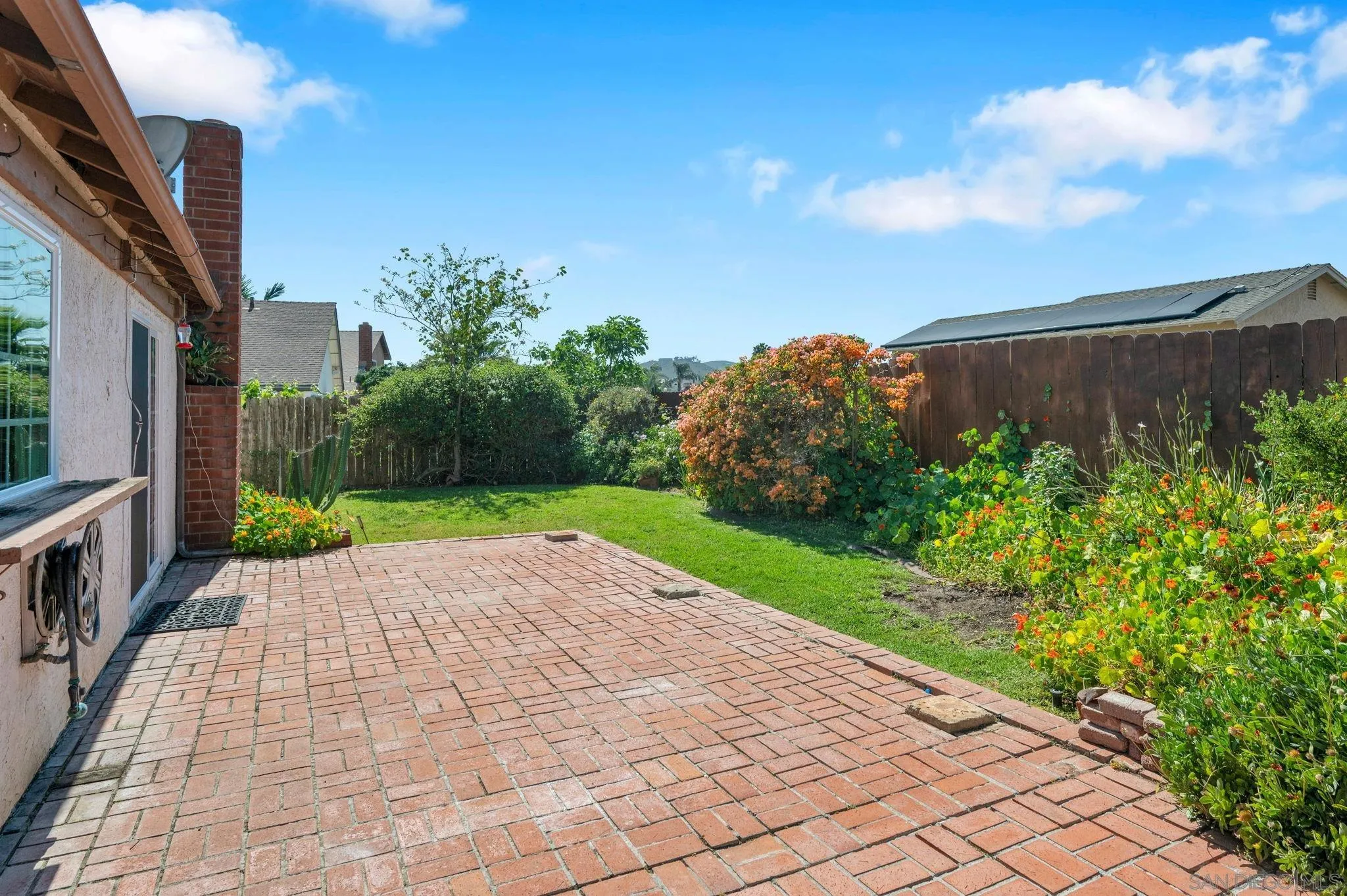 10834 Buggywhip Drive Spring Valley, CA 91978 - Photo 29 of 36 a view of backyard with potted plants and a palm tree