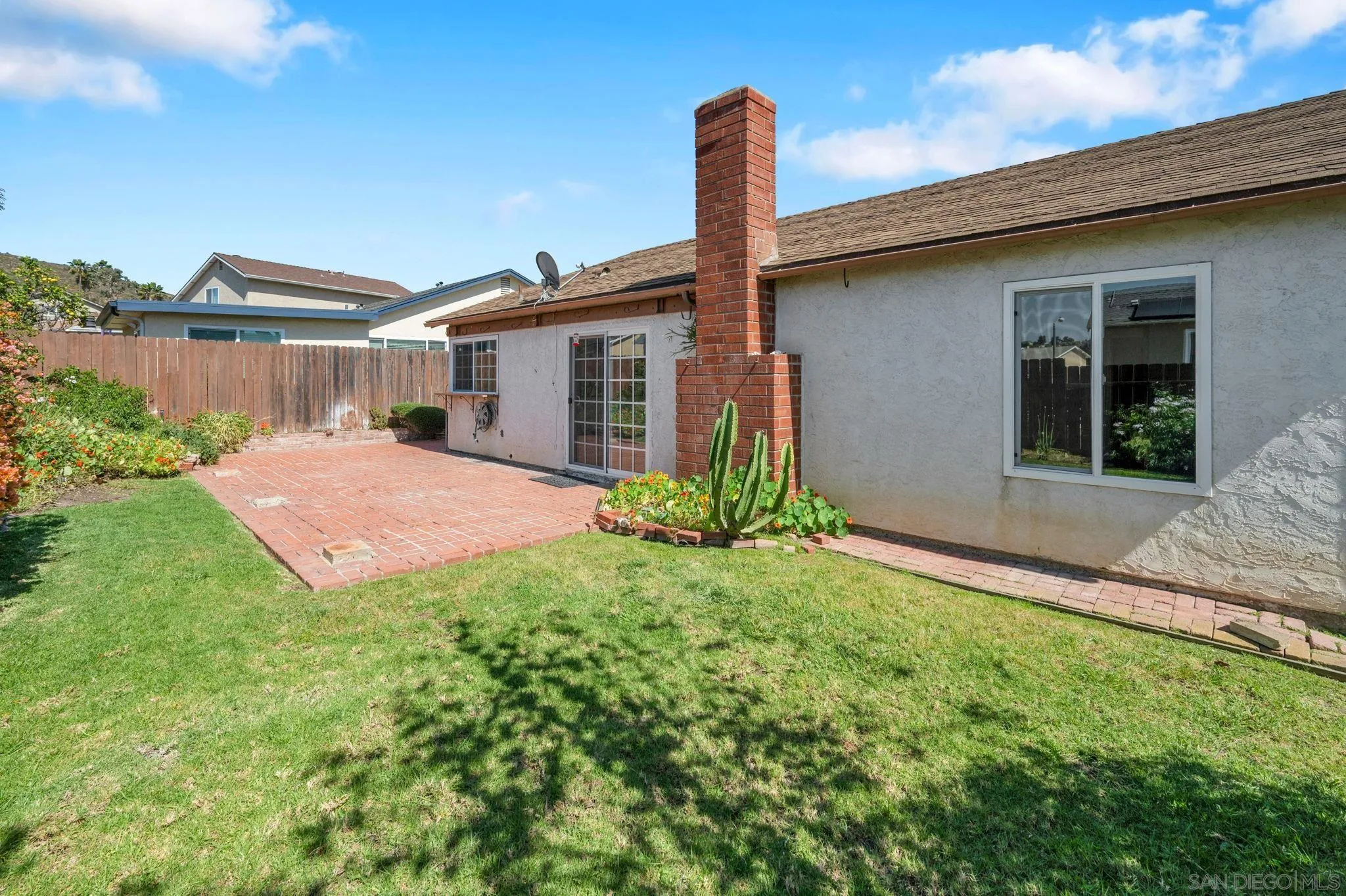 10834 Buggywhip Drive Spring Valley, CA 91978 - Photo 30 of 36 a front view of a house with yard and glass windows