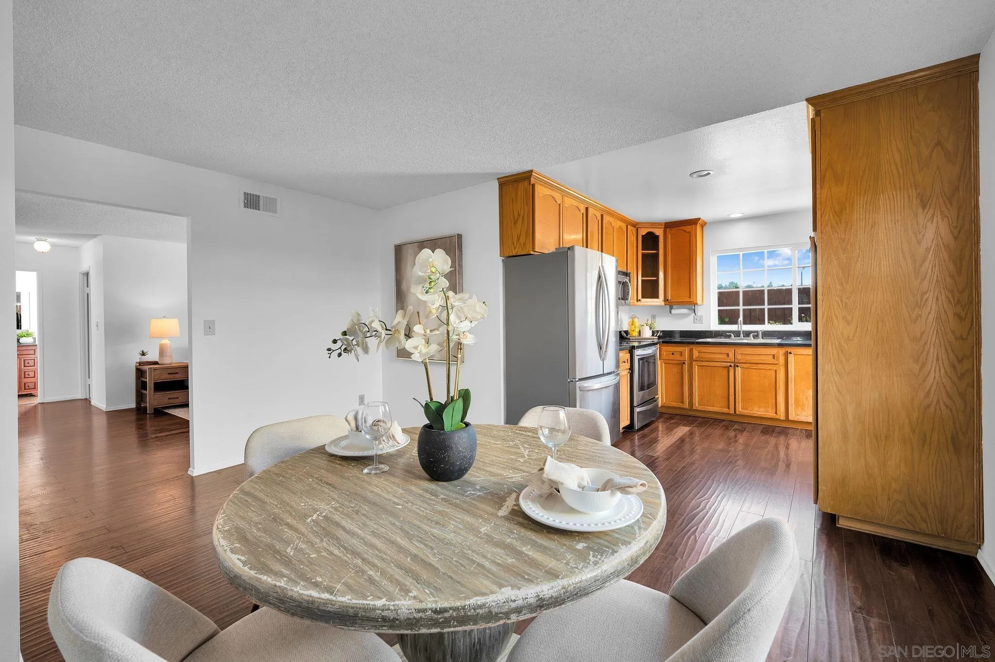 10834 Buggywhip Drive Spring Valley, CA 91978 - Photo 8 of 36 a dining room with furniture and wooden floor