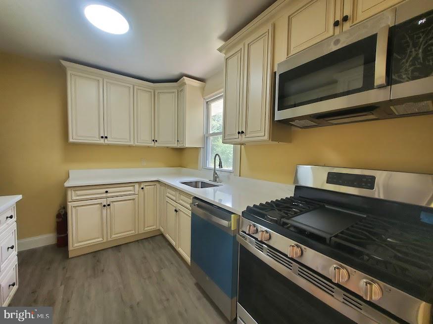 300 Ridge Road Browns Mills, NJ 08015 - Photo 2 of 28 a kitchen with stainless steel appliances granite countertop a stove a sink and a microwave