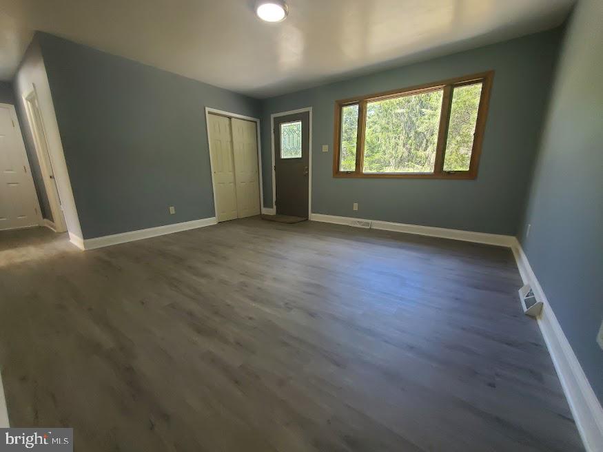 300 Ridge Road Browns Mills, NJ 08015 - Photo 4 of 28 an empty room with wooden floor and windows