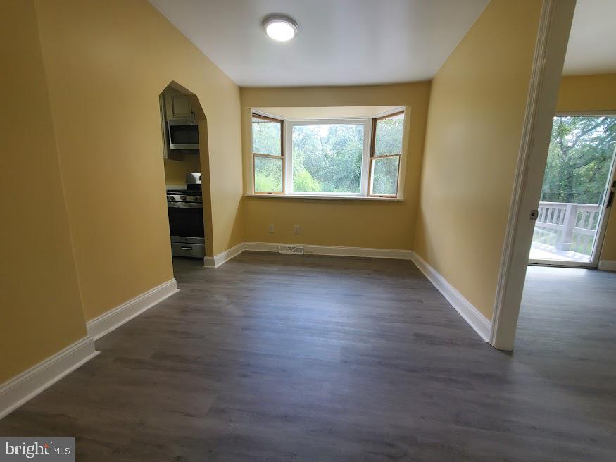300 Ridge Road Browns Mills, NJ 08015 - Photo 9 of 28 an empty room with wooden floor and windows
