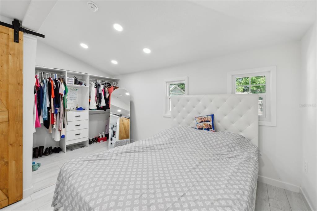 1626 Gar Street St. Cloud, FL 34771 - Photo 14 of 45 a bedroom with a bed and a large mirror