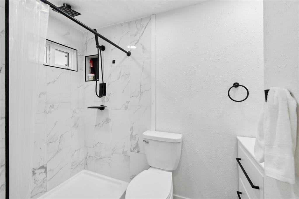 1626 Gar Street St. Cloud, FL 34771 - Photo 21 of 45 a white toilet sitting next to a bath tub shower