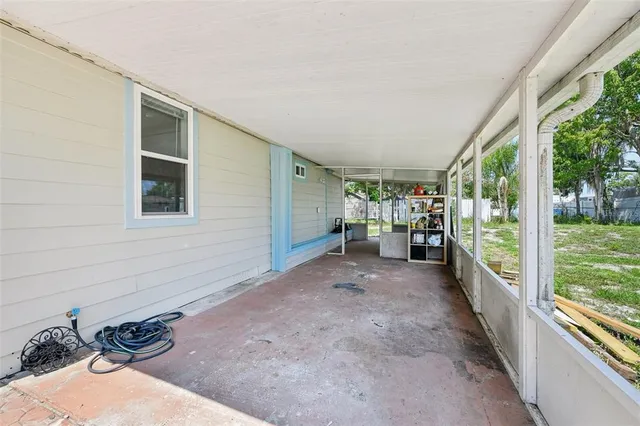 a view of a porch with furniture and garden