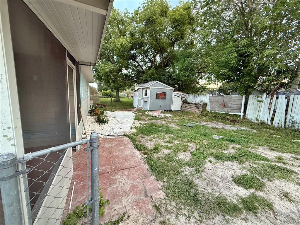 1626 Gar Street St. Cloud, FL 34771 - Photo 29 of 45 a front view of a house with a yard