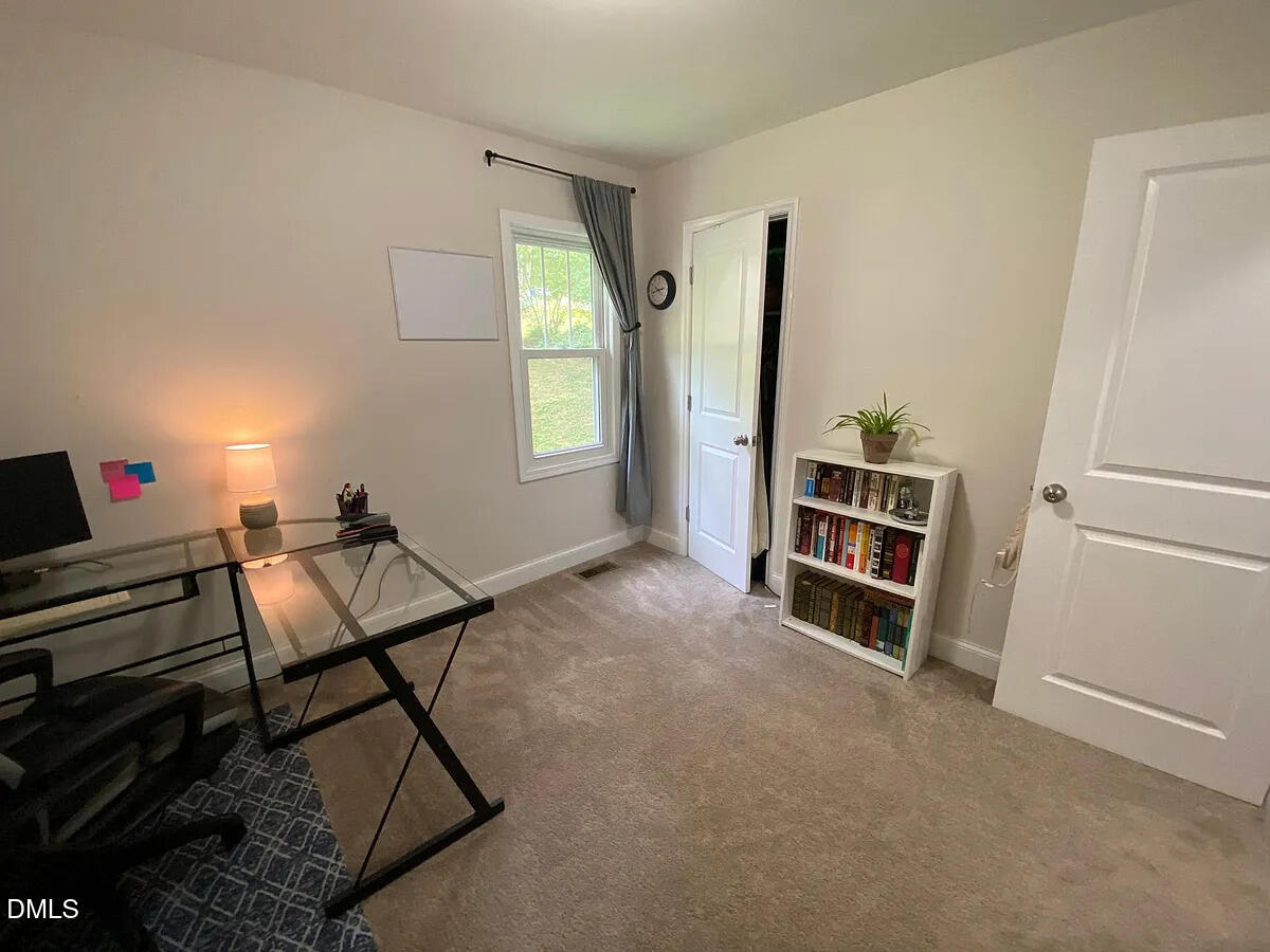 7501 Post Oak Road Raleigh, NC 27615 - Photo 18 of 40 a living room with furniture and a window