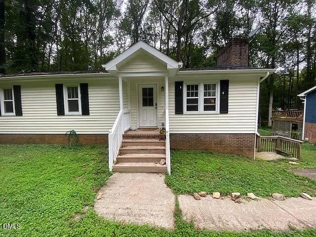 7501 Post Oak Road Raleigh, NC 27615 - Photo 2 of 40 a front view of a house with a yard