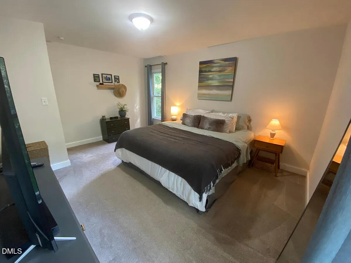 7501 Post Oak Road Raleigh, NC 27615 - Photo 25 of 40 a bedroom with a bed and a night stand
