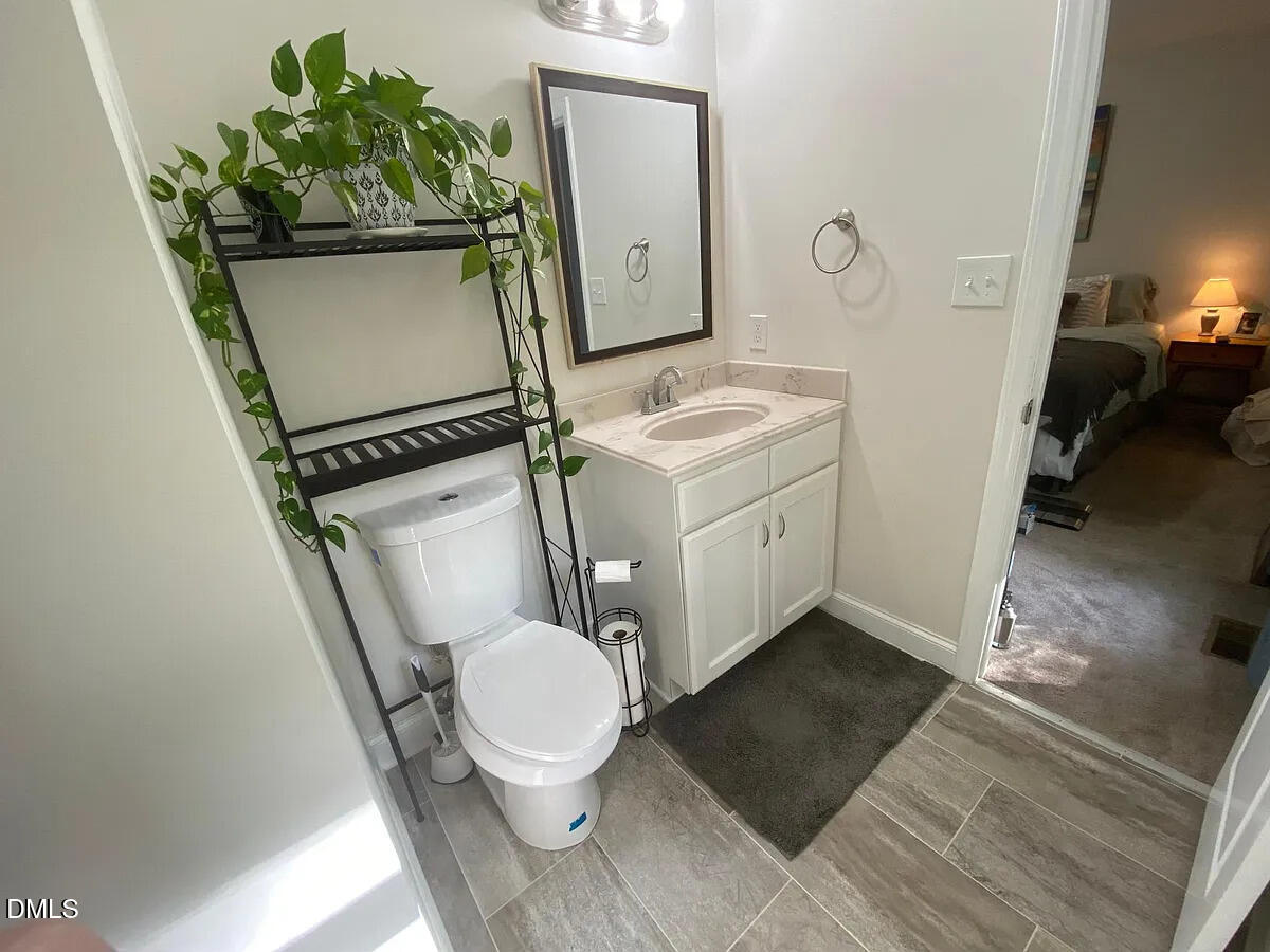 7501 Post Oak Road Raleigh, NC 27615 - Photo 28 of 40 a bathroom with a sink toilet and mirror
