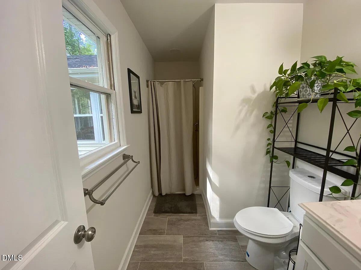 7501 Post Oak Road Raleigh, NC 27615 - Photo 29 of 40 a bathroom with a toilet and a shower