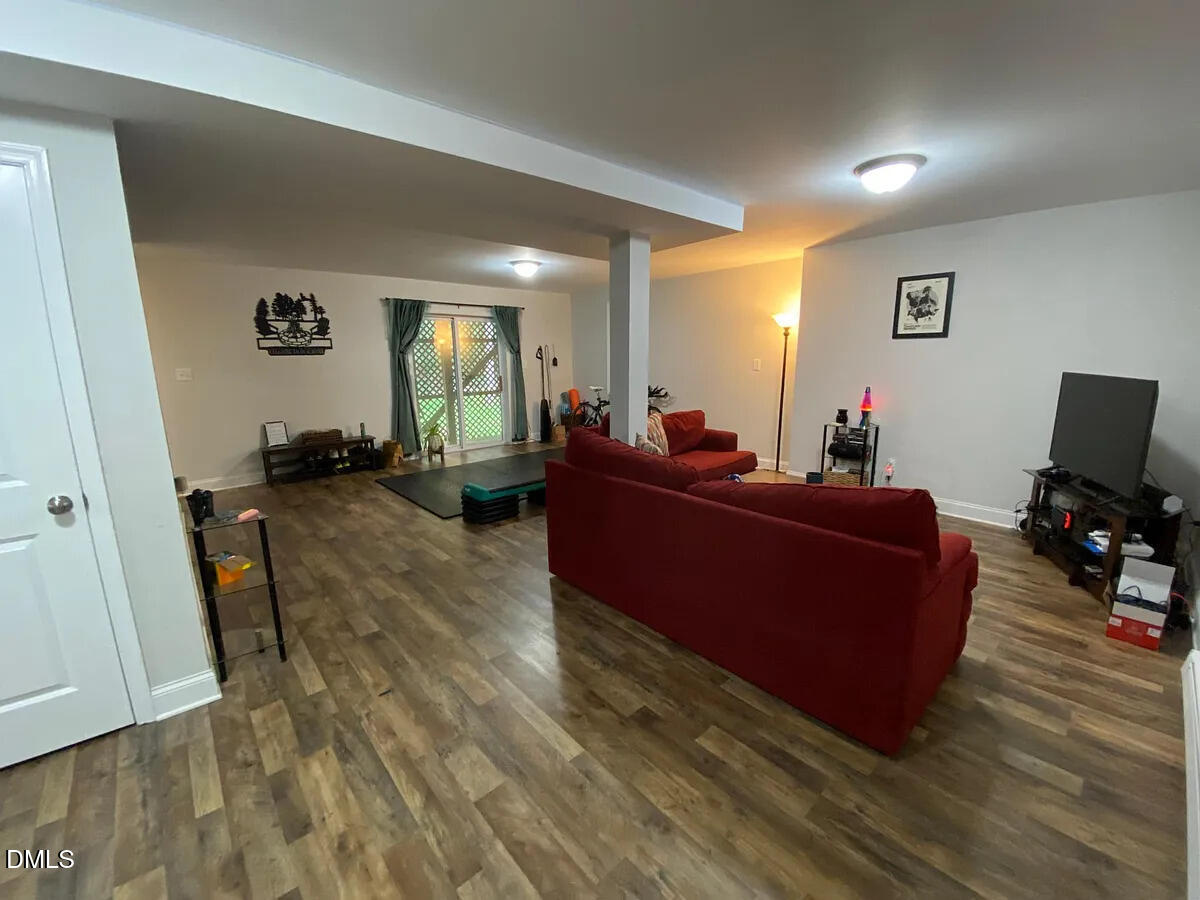 7501 Post Oak Road Raleigh, NC 27615 - Photo 37 of 40 a living room with furniture and a flat screen tv