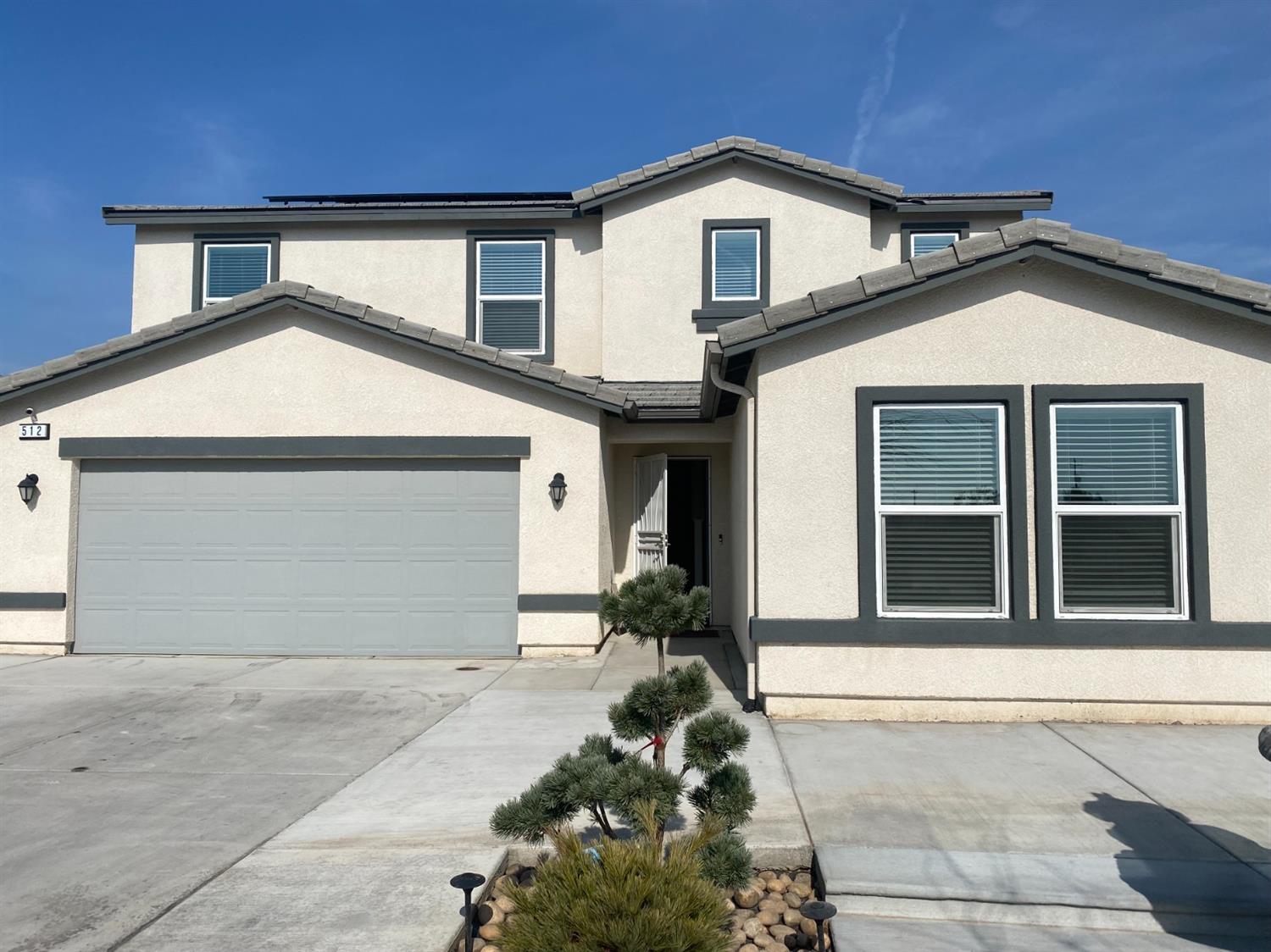 512 Barbara Avenue Sanger, CA 93657 - Photo 1 of 40 a front view of a house with a yard