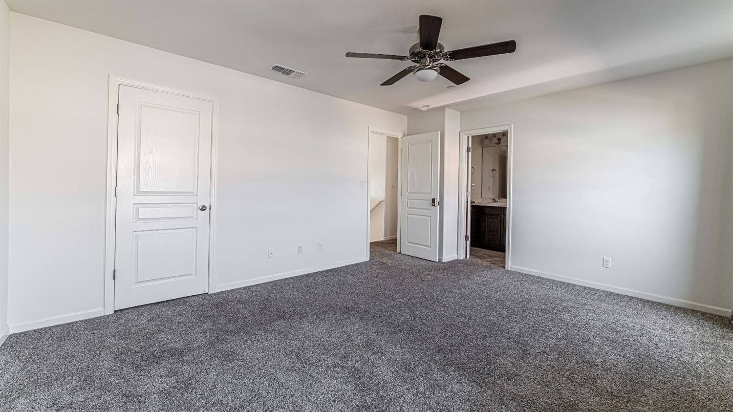 512 Barbara Avenue Sanger, CA 93657 - Photo 23 of 40 an empty room with a ceiling fan and carpet