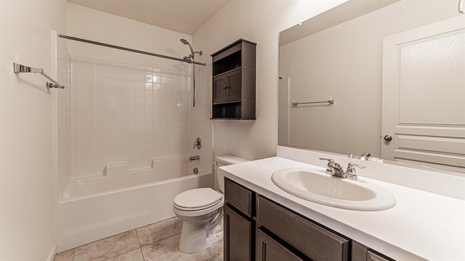 512 Barbara Avenue Sanger, CA 93657 - Photo 26 of 40 a bathroom with a sink toilet and shower