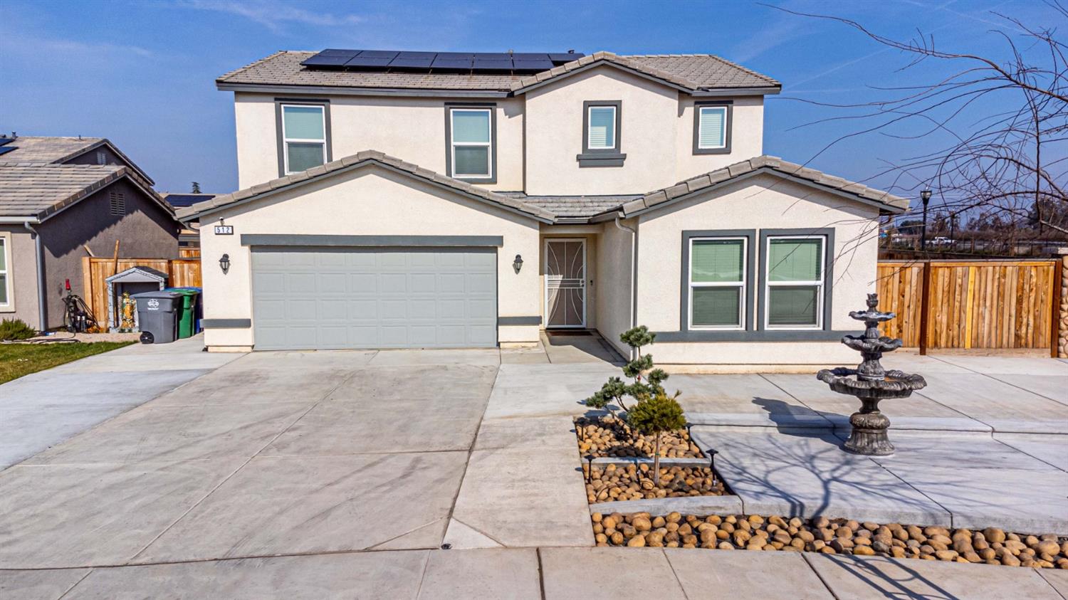 512 Barbara Avenue Sanger, CA 93657 - Photo 6 of 40 a front view of a house with a yard and garage