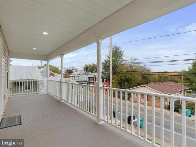 an aerial view of residential houses with outdoor space and trees