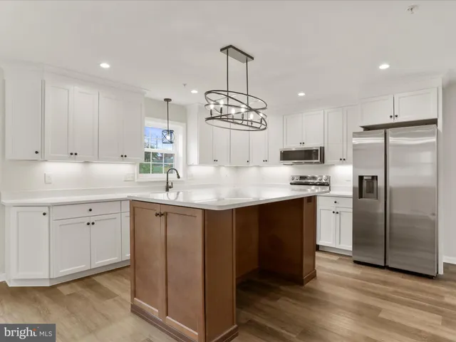 a kitchen with stainless steel appliances white cabinets and a stove