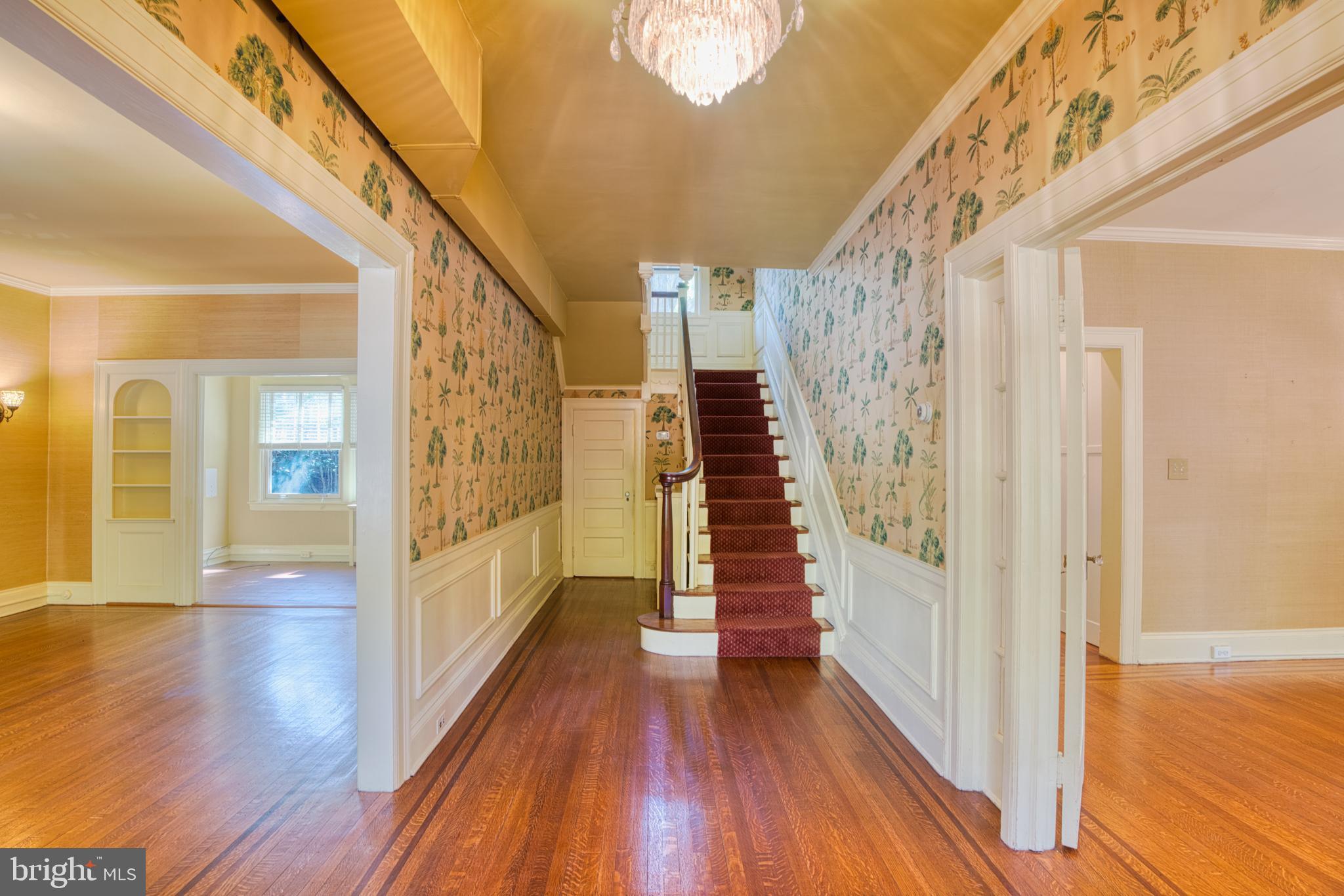 3925 Canterbury Road Baltimore, MD 21218 - Photo 3 of 65 a view of a hallway with wooden floor and staircase