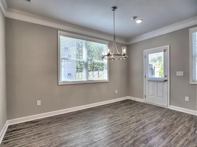 a view of kitchen with refrigerator and microwave