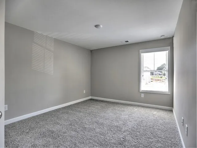 a bedroom with a bed and a chair