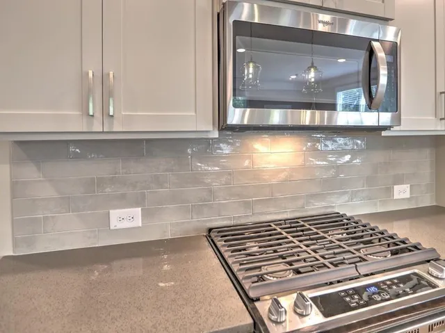 a open kitchen with a sink dishwasher a fireplace with wooden floor