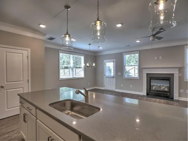 a kitchen with stainless steel appliances granite countertop a refrigerator a sink and a stove