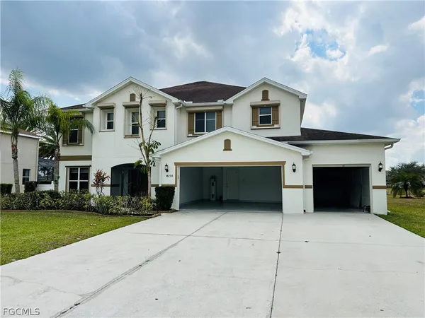 a front view of house with yard and garage