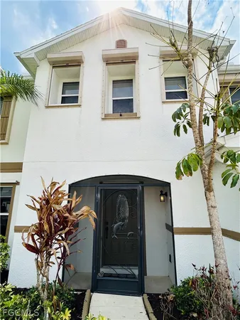 a front view of a house with lots of potted plants