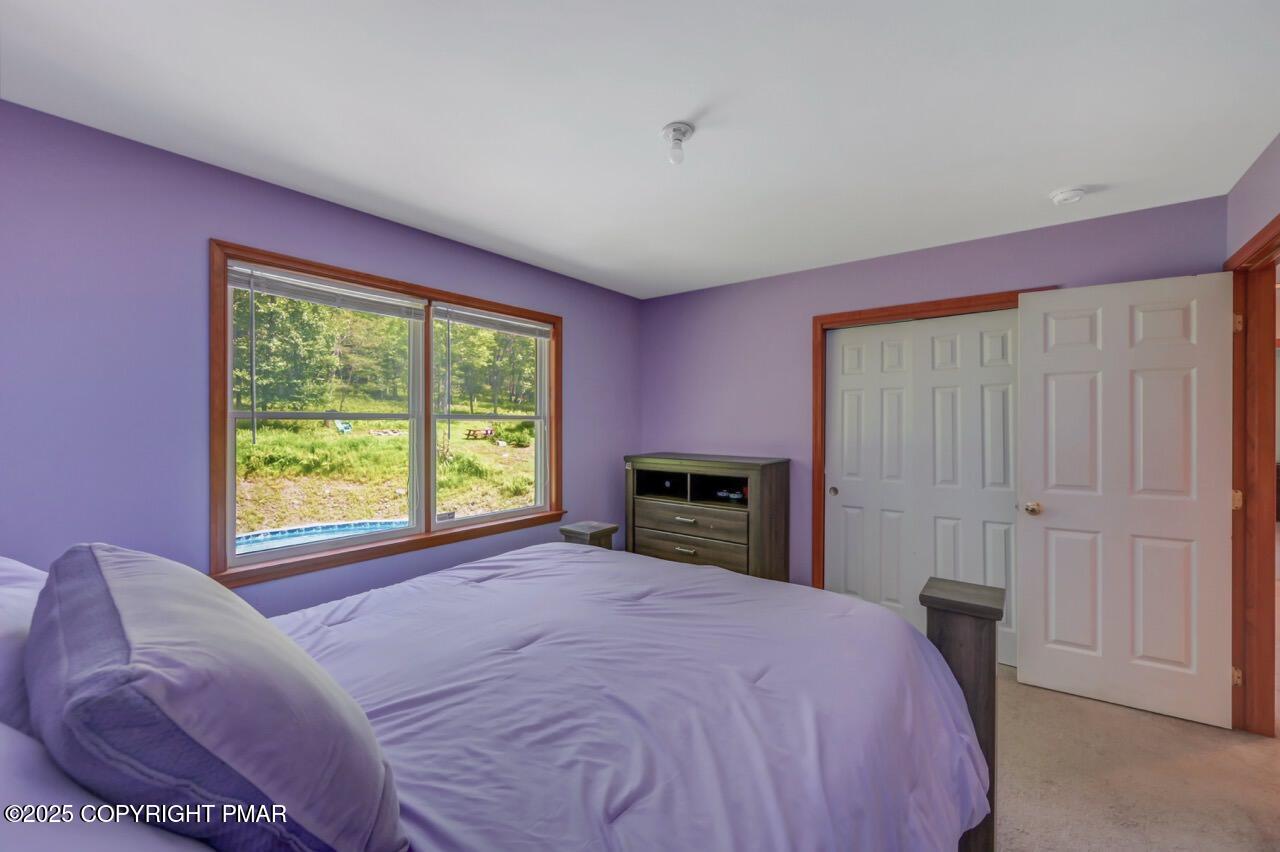 649 Snow Hill Road Cresco, PA 18326 - Photo 18 of 31 a bed room with a bed and a chair