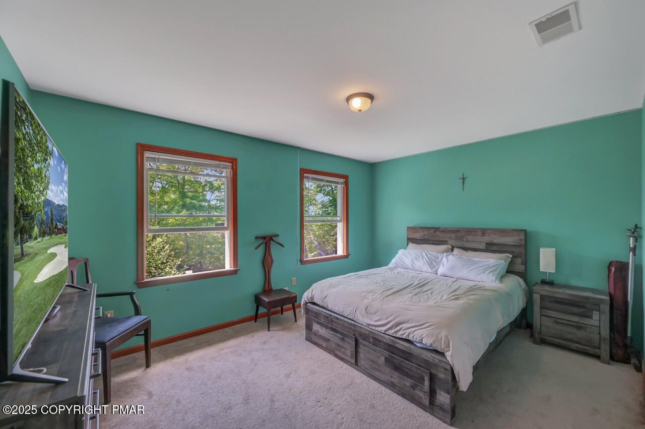 649 Snow Hill Road Cresco, PA 18326 - Photo 20 of 31 a bedroom with a bed and a window